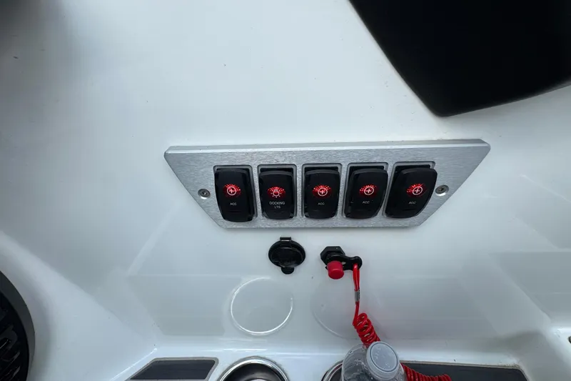 Slide: The Image of Control panel of a 2021 Supreme ZS232 boat with switches and safety lanyard. - 18