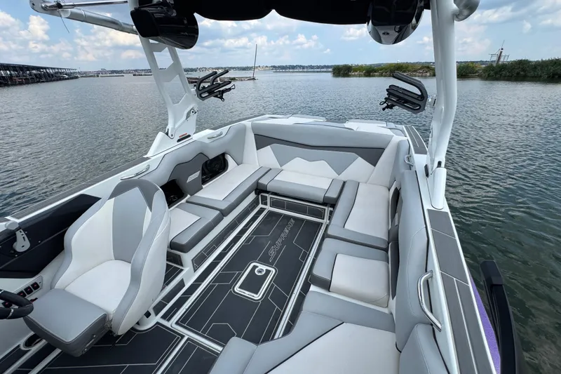Slide: The Image of 2021 Supreme ZS232 boat interior with sleek seating and modern design on a calm lake. - 22
