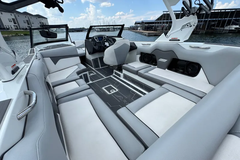 Slide: The Image of 2021 Supreme ZS232 boat interior with sleek seating and modern design on a sunny day. - 24