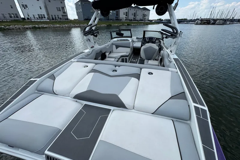 Slide: The Image of 2021 Supreme ZS232 boat interior with sleek seating on a calm lake. - 28
