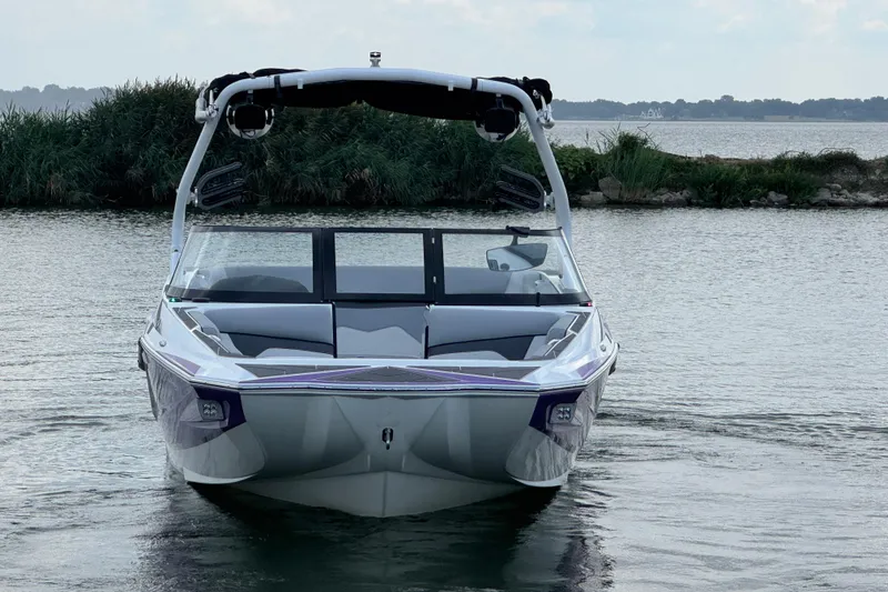 Slide: The Image of 2021 Supreme ZS232 boat on calm water, front view with lush greenery background. - 3