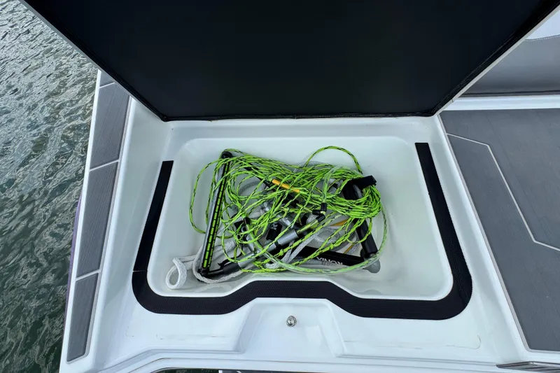 Slide: The Image of Open storage compartment on 2021 Supreme ZS232 boat with green rope inside. - 30