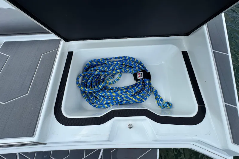 Slide: The Image of Storage compartment in 2021 Supreme ZS232 boat with blue and yellow rope. - 31