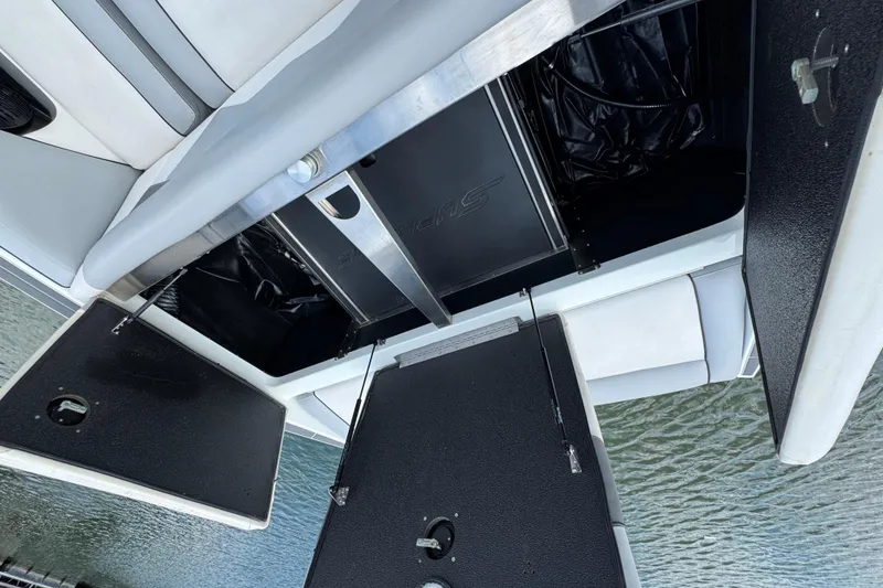 Slide: The Image of 2021 Supreme ZS232 boat storage compartments open, revealing interior details. - 33