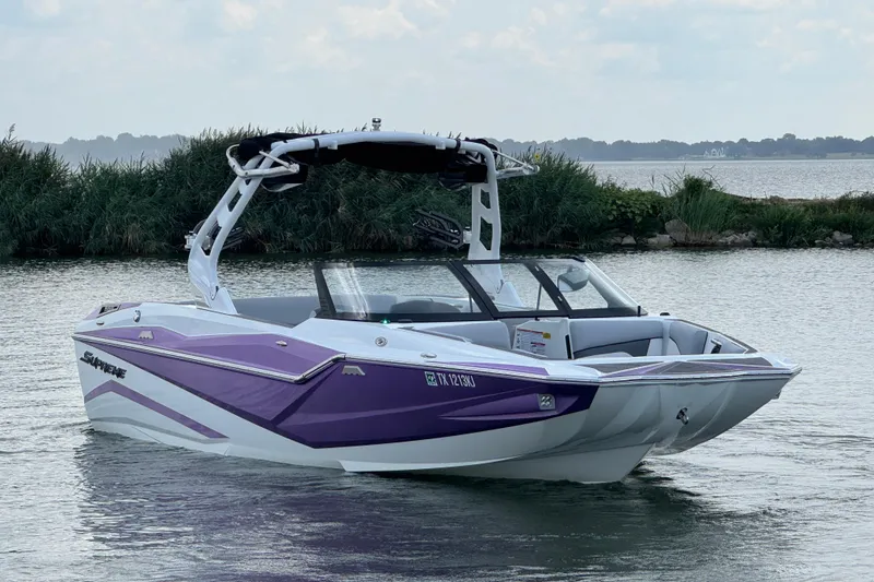 Slide: The Image of 2021 Supreme ZS232 boat in purple and white on a calm lake. - 4