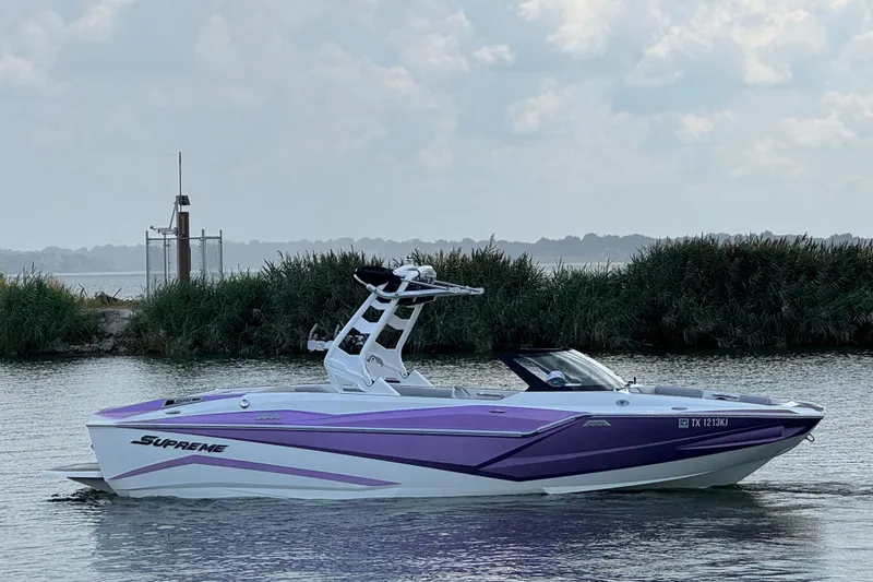 Slide: The Image of 2021 Supreme ZS232 boat with purple accents on a calm lake. - 5