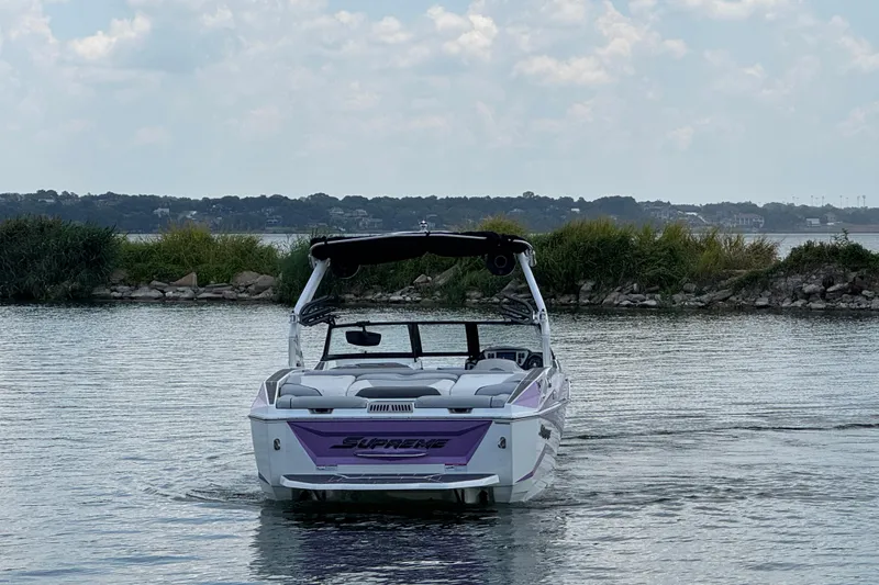 Slide: The Image of 2021 Supreme ZS232 boat on a calm lake with scenic background. - 7