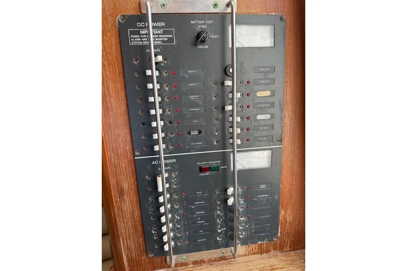 Slide: The Image of Electrical panel on a 2003 Pursuit 3000 Offshore boat, featuring DC and AC power controls. - 20