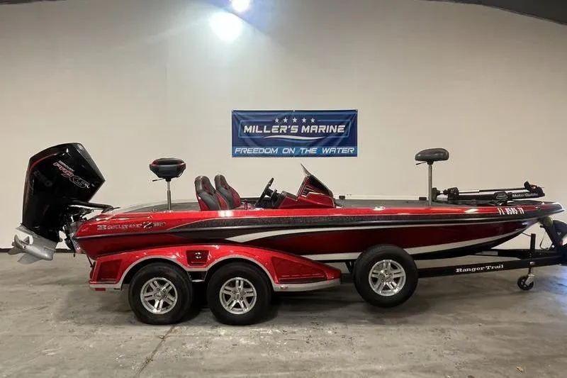 The Image of 2022 Ranger Z520R bass boat in showroom, red and black design, displayed at Miller's Marine. - 0