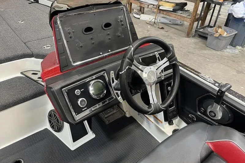 Slide: The Image of 2022 Ranger Z520R boat cockpit with steering wheel and control panel. - 10