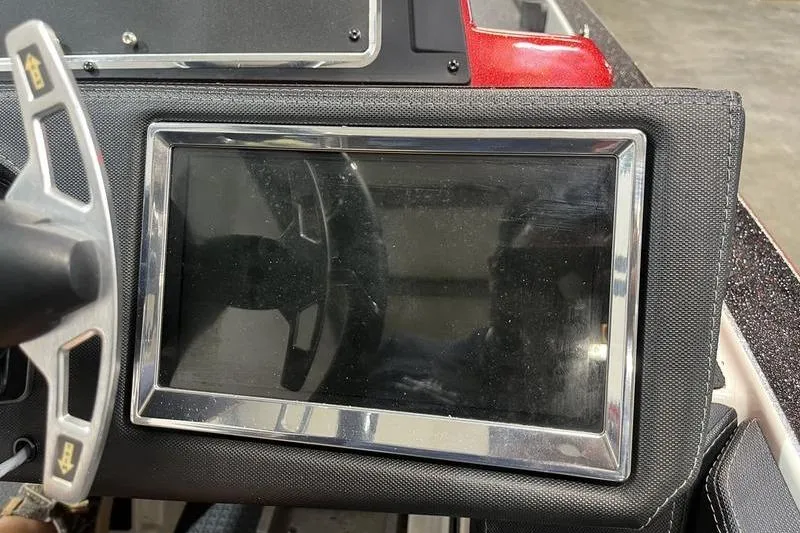 Slide: The Image of Dashboard of a 2022 Ranger Z520R boat with steering wheel and display screen. - 12
