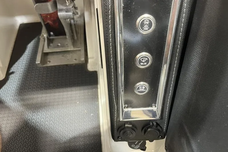 Slide: The Image of Control panel of 2022 Ranger Z520R boat with switches for lights, bilge, and livewell. - 13