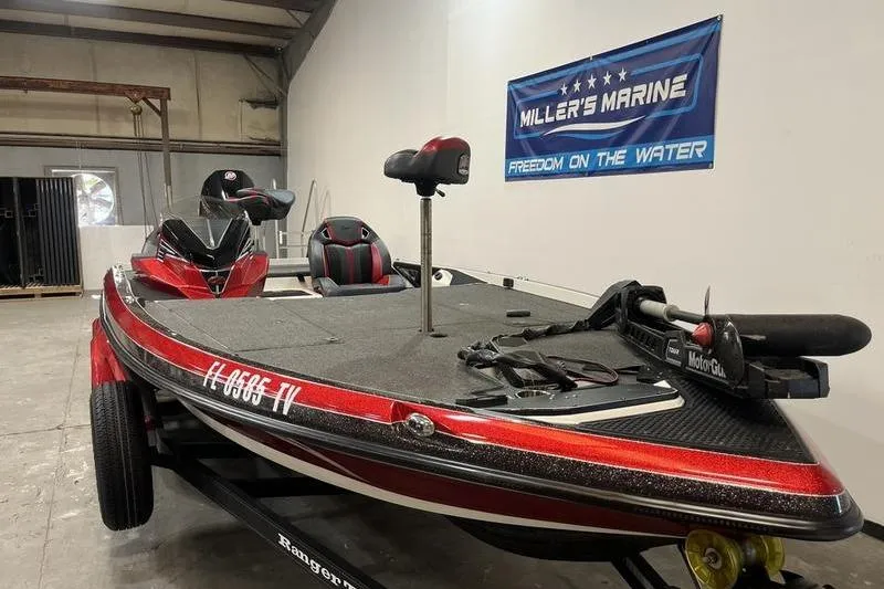 Slide: The Image of 2022 Ranger Z520R boat in showroom, featuring red accents and fishing equipment. - 2