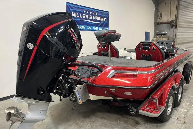 Slide: The Image of 2022 Ranger Z520R bass boat in showroom, featuring powerful engine and sleek red design. - 3