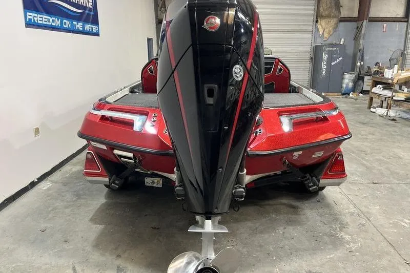 Slide: The Image of 2022 Ranger Z520R boat with a powerful outboard motor in a garage setting. - 4