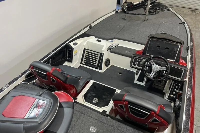 Slide: The Image of 2022 Ranger Z520R boat interior with steering wheel and seating, featuring red and black accents. - 9
