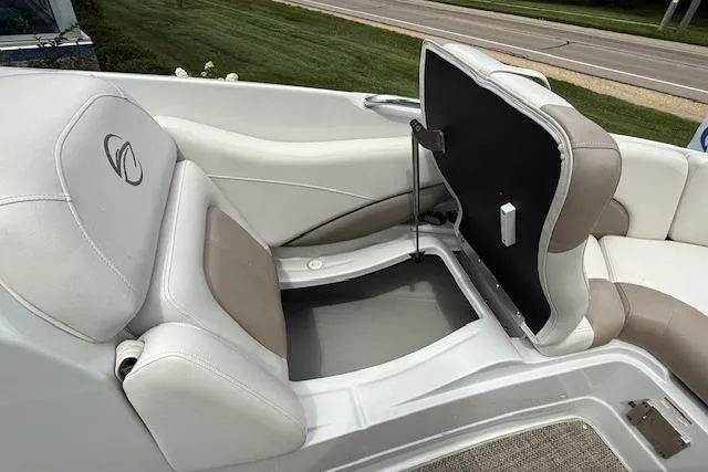 Slide: The Image of 2018 Crownline 255 SS boat interior with open storage compartment and cushioned seating. - 15