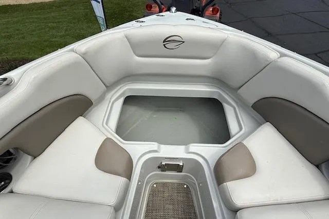 Slide: The Image of 2018 Crownline 255 SS boat interior with white and beige seating. - 16