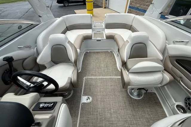 Slide: The Image of 2018 Crownline 255 SS boat interior with plush seating and modern steering wheel. - 17