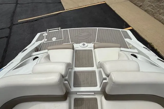 Slide: The Image of 2018 Crownline 255 SS boat interior with cushioned seating and teak-style flooring. - 19