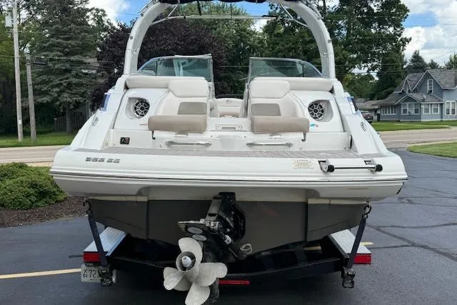 Slide: The Image of 2018 Crownline 255 SS boat on trailer, rear view, parked outdoors. - 2