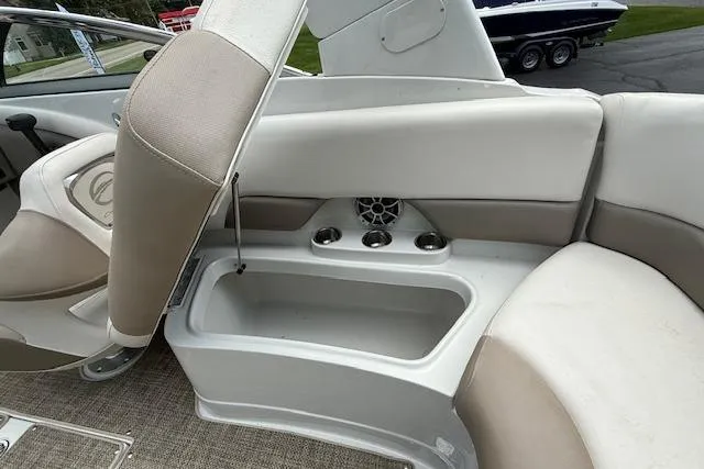 Slide: The Image of 2018 Crownline 255 SS boat interior with storage compartment and cup holders. - 20