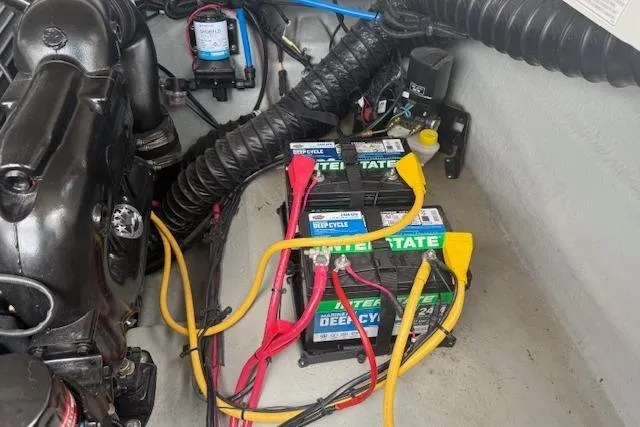 Slide: The Image of Engine compartment of a 2018 Crownline 255 SS with dual marine batteries and wiring. - 24