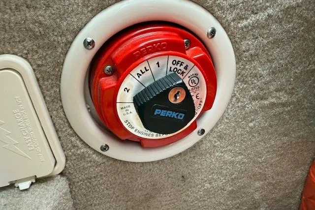 Slide: The Image of Battery switch on 2018 Crownline 255 SS boat, featuring Perko dial and safety instructions. - 26