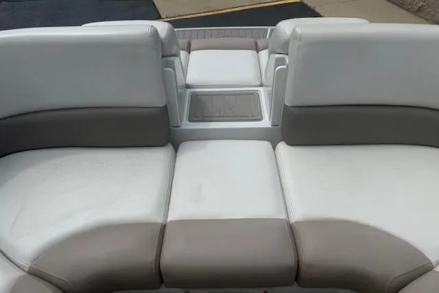 Slide: The Image of 2018 Crownline 255 SS boat interior with white and beige seating. - 28