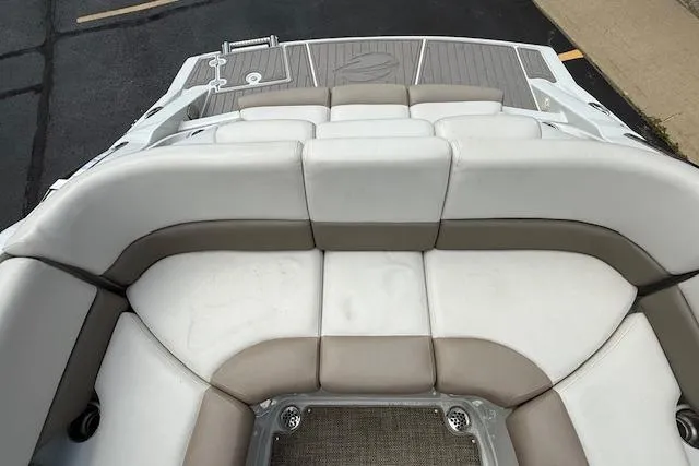 Slide: The Image of 2018 Crownline 255 SS boat with spacious, cushioned seating and sleek design. - 31