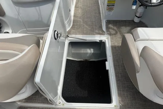 Slide: The Image of 2018 Crownline 255 SS boat interior with open storage compartment and seating. - 34