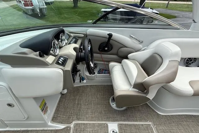 Slide: The Image of 2018 Crownline 255 SS boat interior with steering wheel and seating area. - 8
