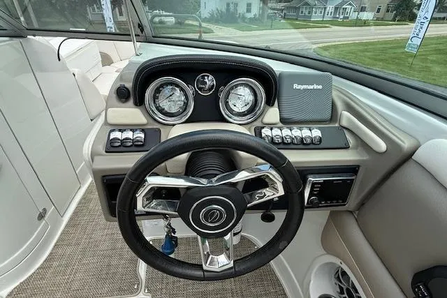 Slide: The Image of 2018 Crownline 255 SS boat dashboard with steering wheel and Raymarine navigation system. - 9