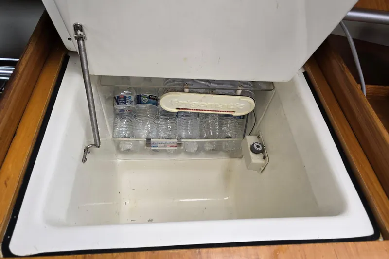 Slide: The Image of Built-in cooler with water bottles inside a 1991 Beneteau 35.5 S5 sailboat. - 11