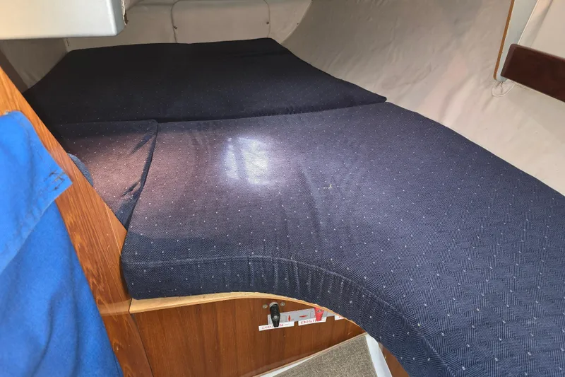 Slide: The Image of Interior cabin of 1991 Beneteau 35.5 S5 sailboat with blue bedding. - 13