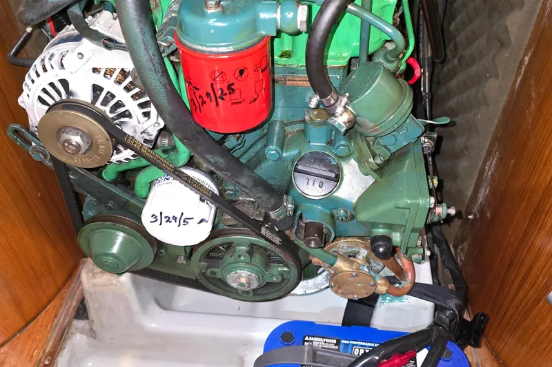 Slide: The Image of Engine of a 1991 Beneteau 35.5 S5 sailboat, featuring belts and filters. - 24