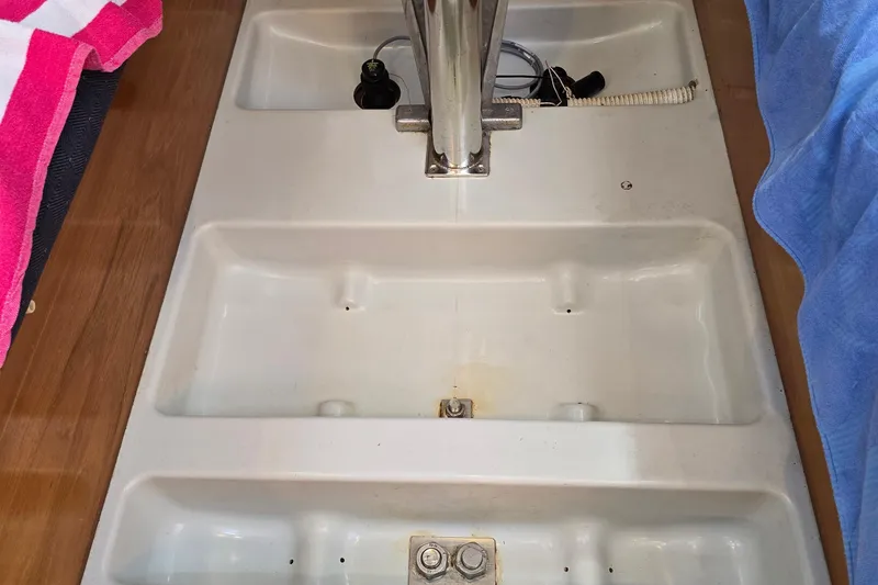 Slide: The Image of Interior view of a 1991 Beneteau 35.5 S5 sailboat, featuring a clean, white compartment. - 25