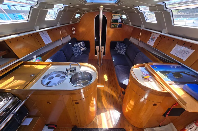 Slide: The Image of Interior of 1991 Beneteau 35.5 S5 sailboat with wood finish and cozy seating. - 4