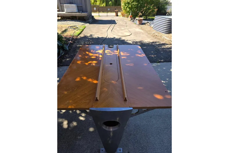 Slide: The Image of Wooden table from a 1991 Beneteau 35.5 S5 sailboat, outdoors in sunlight. - 5