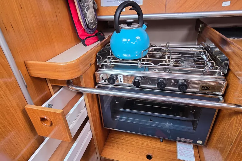 Slide: The Image of Compact kitchen in 1991 Beneteau 35.5 S5 yacht with stove and blue kettle. - 9
