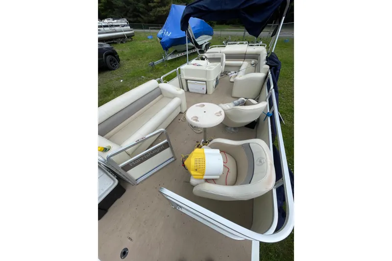 Slide: The Image of 1999 Harris Super Sunliner 240 pontoon boat with beige seating and open deck layout. - 7