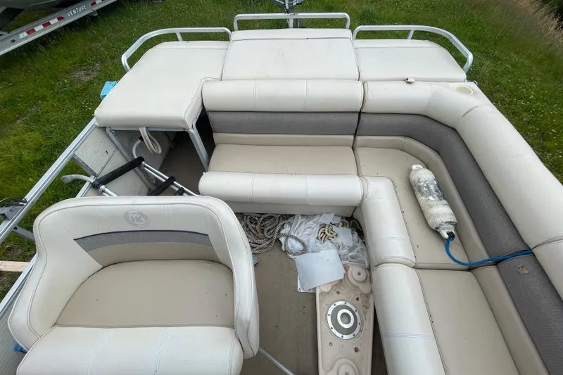 Slide: The Image of 1999 Harris Super Sunliner 240 pontoon boat interior with white seating and accessories. - 9