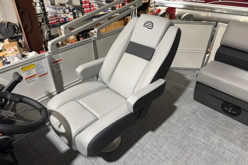 Slide: The Image of 2026 Sun Tracker Party Barge 20 DLX captain's chair, featuring sleek gray upholstery. - 11