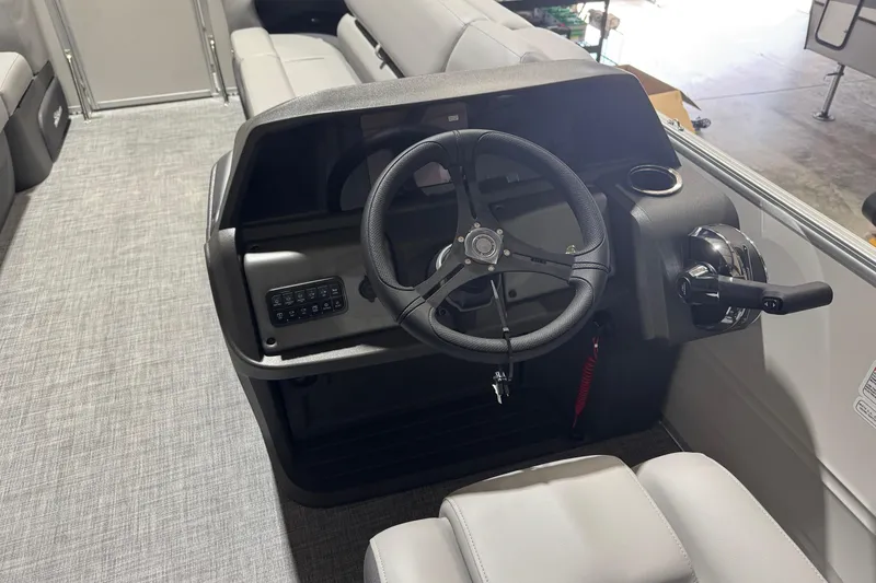 Slide: The Image of 2026 Sun Tracker Party Barge 20 DLX steering console with modern controls and seating. - 12
