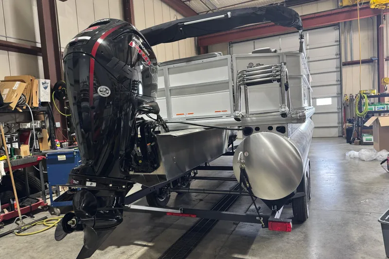Slide: The Image of 2026 Sun Tracker Party Barge 20 DLX pontoon boat in a workshop setting. - 3
