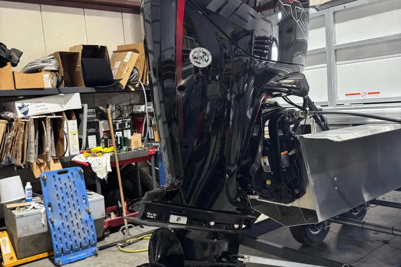 Slide: The Image of 2026 Sun Tracker Party Barge 20 DLX motor in a workshop setting. - 5