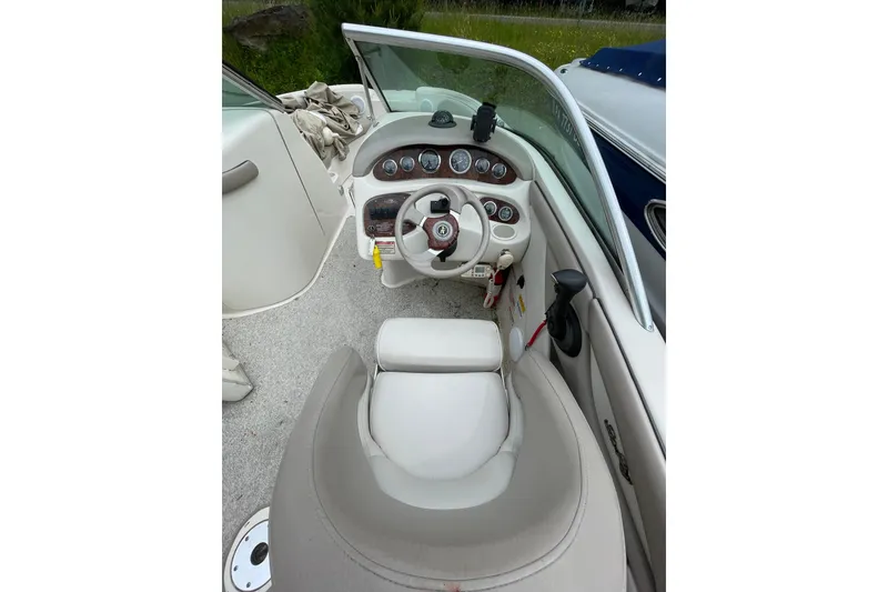 Slide: The Image of Interior view of a 2002 Sea Ray 210 Sundeck boat cockpit with steering wheel and gauges. - 11
