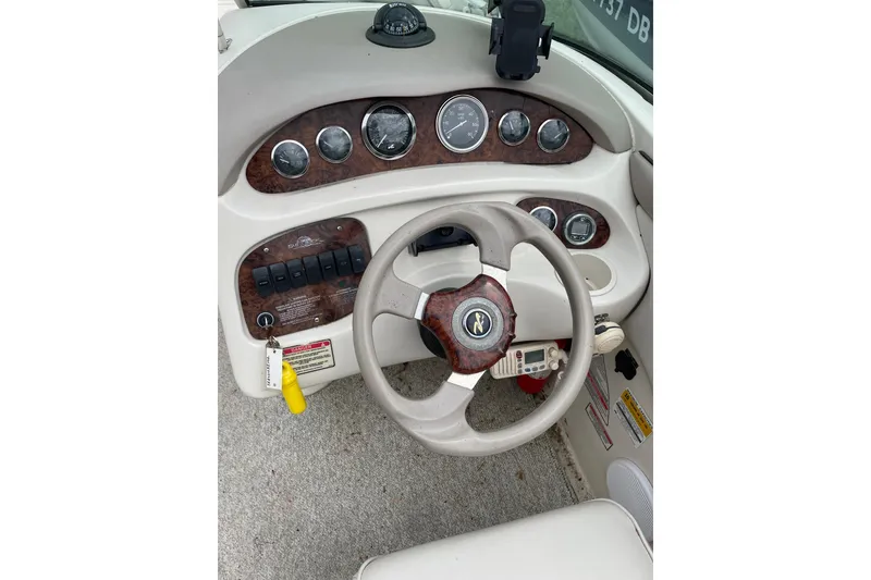 Slide: The Image of Steering console of a 2002 Sea Ray 210 Sundeck boat with gauges and controls. - 4