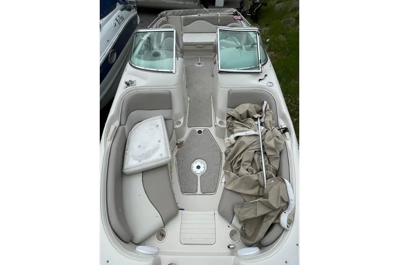 Slide: The Image of 2002 Sea Ray 210 Sundeck interior with seating and storage compartments. - 6