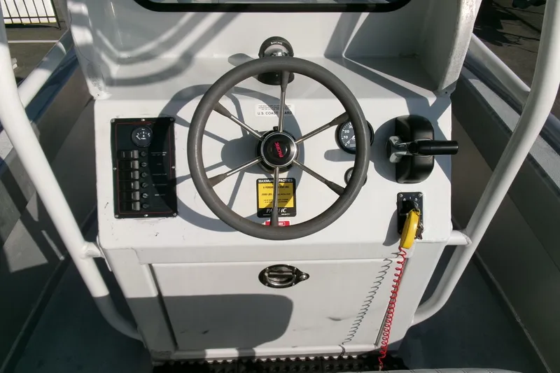 Slide: The Image of 2003 Pacific Boats 2025 V steering console with controls and gauges. - 11